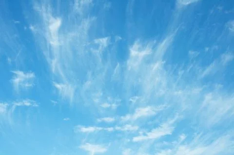 Bright blue sky background with tiny clouds. Sunny day Stock Photos