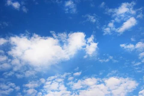 Bright blue sky background with tiny clouds. Sunny day. Stock Photos