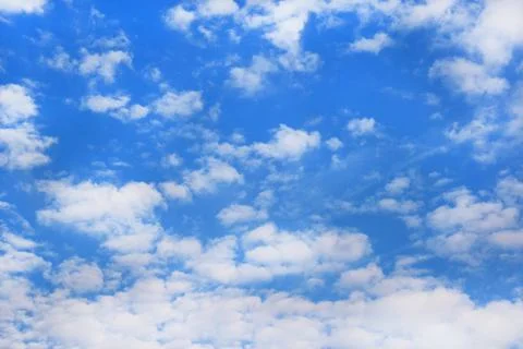Bright blue sky background with tiny clouds. Sunny day. Stock Photos