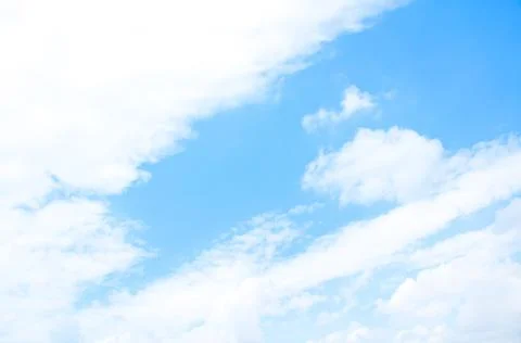 Bright blue sky background with tiny clouds. Sunny day. Stock Photos