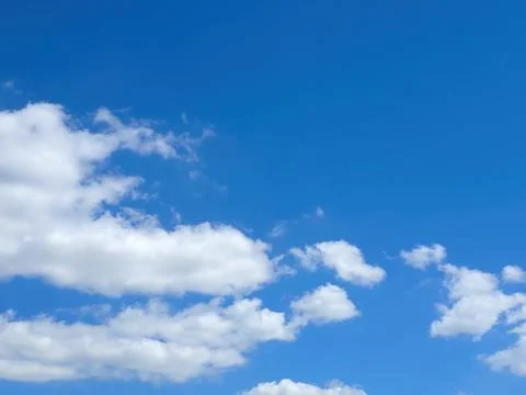 Bright Blue Sky With Clouds Over a Clear Day in Open Space Above Ground Stock Photos