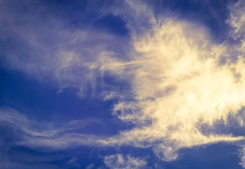 Bright blue sky with clouds with sunset lights, background for design, decora Stock Photos