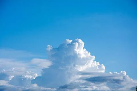 Bright blue sky with cumulus clouds forming on summer day Stock Photos