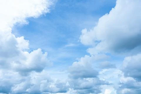 Bright blue sky with dramatic white and grey cumulus clouds 스톡 사진