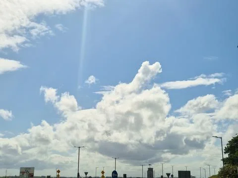 Bright blue sky with dramatic white clouds Stock Photos