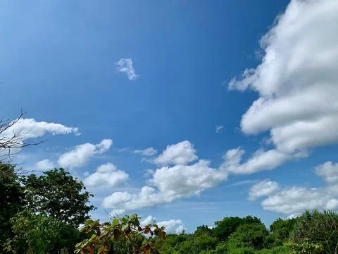 Bright Blue Sky with Dramatic White Clouds at Tanjung Lesung Beach Stock Photos