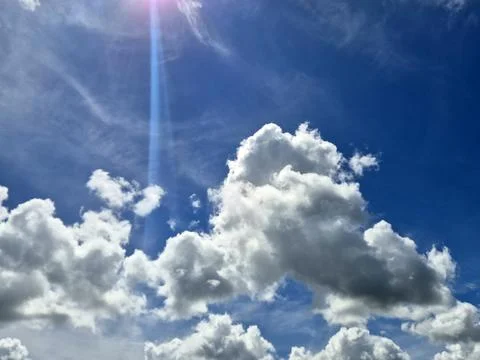 Bright blue sky with dramatic white clouds Stock Photos