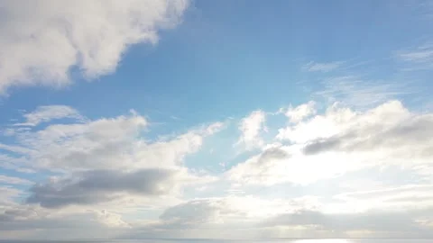 Bright blue sky with drifting clouds creating peaceful natural atmosphere Stock Footage 327840270