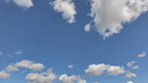 Bright Blue Sky with Drifting White Cumulus Clouds Overhead Stock Footage 346140688