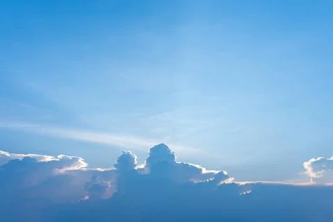 Bright blue sky featuring soft white cumulus clouds illuminated Stock Photos