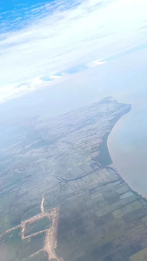 Bright blue sky with fluffy clouds, showing view of islands and cityscape below Video stock 312730302