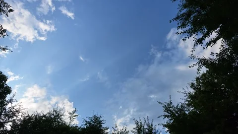 Bright blue sky, fluffy clouds drift lazily above Stock Footage 340064929