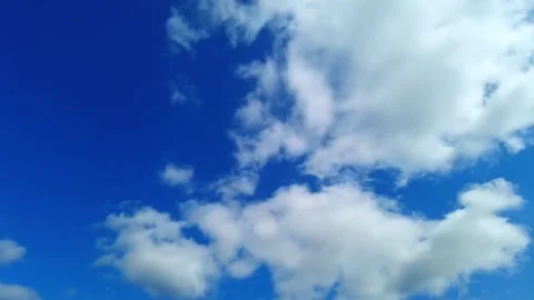 Bright Blue Sky With Fluffy White Clouds Drifting Slowly On A Sunny Day Stock Footage 342107656