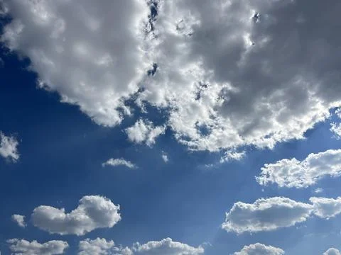 Bright Blue Sky with Fluffy White Cumulus Clouds Stock Photos