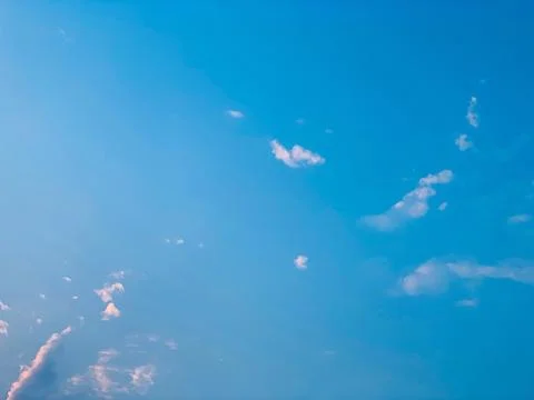 Bright Blue Sky with Scattered Clouds Static Background Stock Photos