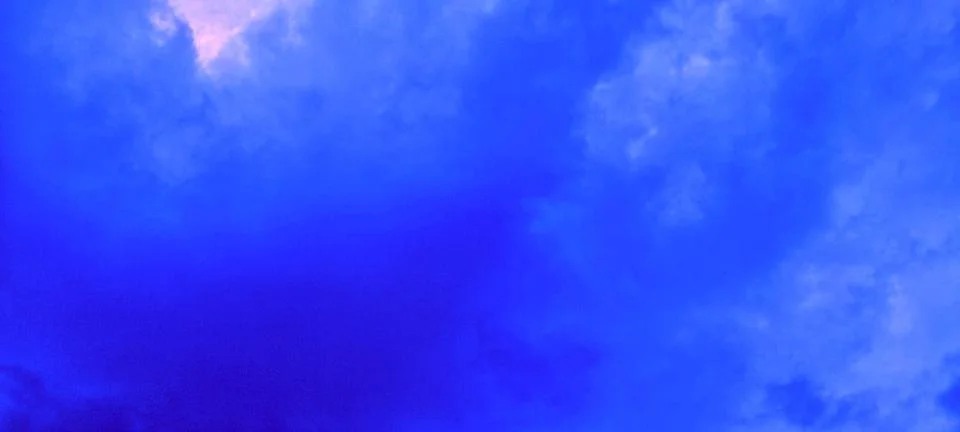 Bright blue sky with soft clouds in the afternoon Stock Photos