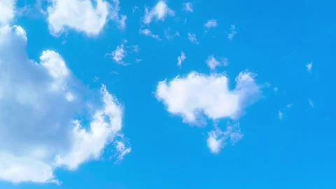 Bright blue sky with soft white clouds on a warm windy vibrant sunny summer day 動画素材 317135698