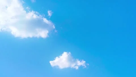 Bright blue sky with soft white clouds on a warm windy vibrant sunny summer day 動画素材 317135785