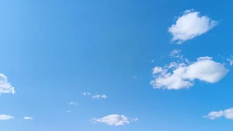 Bright blue sky with soft white clouds on a warm windy vibrant sunny summer day 動画素材 317135818