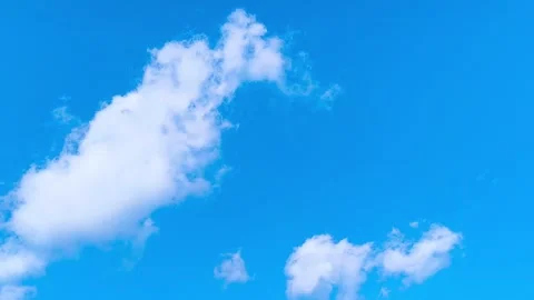 Bright blue sky with soft white clouds on a warm windy vibrant sunny summer day 動画素材 317136013