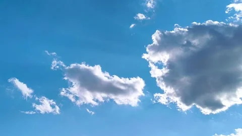 Bright blue sky with soft white clouds on a warm windy vibrant sunny summer day 動画素材 317136015