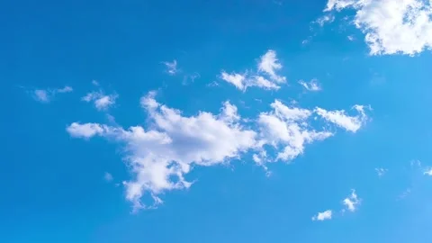 Bright blue sky with soft white clouds on a warm windy vibrant sunny summer day 動画素材 317136128