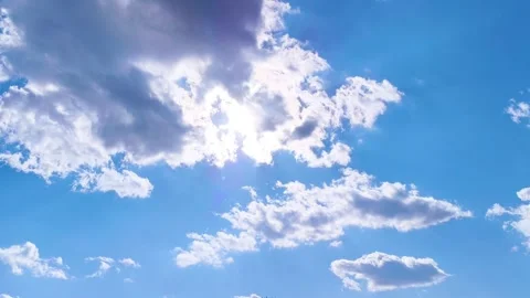 Bright blue sky with soft white clouds on a warm windy vibrant sunny summer day 動画素材 317136188