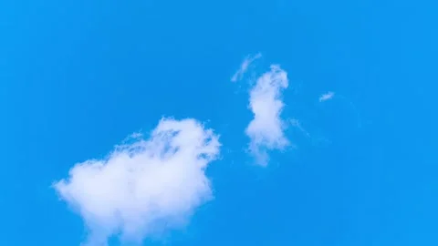 Bright blue sky with soft white clouds on a warm windy vibrant sunny summer day 動画素材 317136347