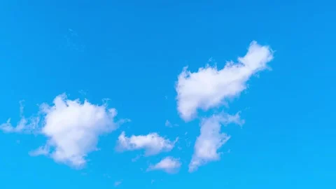 Bright blue sky with soft white clouds on a warm windy vibrant sunny summer day 動画素材 317136376