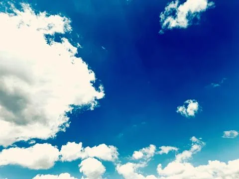 Bright Blue Sky With Soft White Clouds Background. Stock Photos