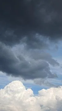 Bright Blue Sky with Soft White Clouds and Foliage 스톡 사진