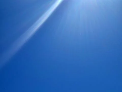 Bright blue sky with sun rays Stock Photos