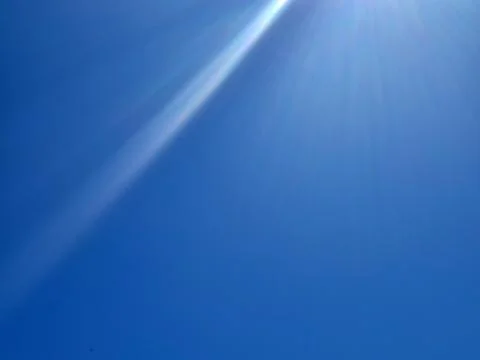 Bright Blue Sky With Sun Rays Stock Photos