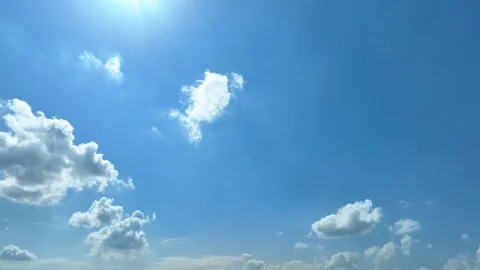 A bright blue sky with sunlight and soft clouds. Stock Footage 340564571