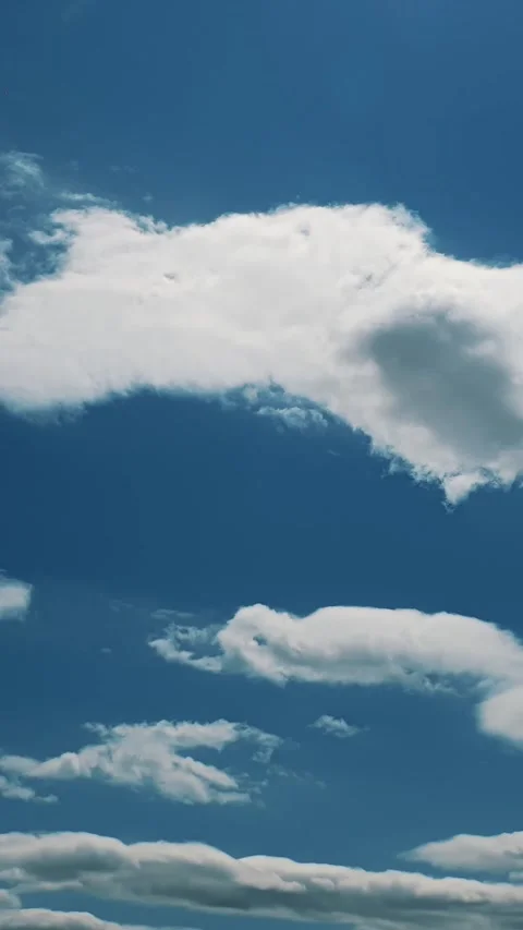 Bright blue sky with thin white cirrus clouds near horizon on clear sunny day Stock Footage 309024296