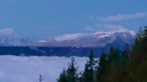 Bright blue sky with white clouds, a large ridge of mountains and a piece Stock Footage 256156867