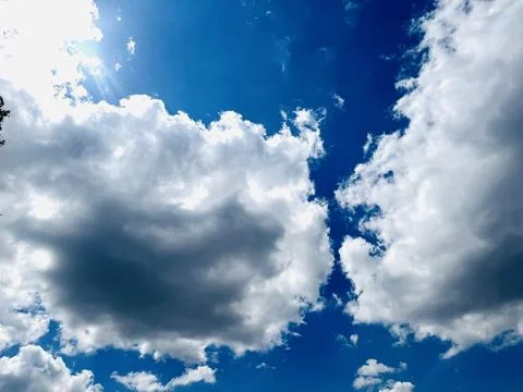 Bright Blue Sky With White Clouds Natural Background. Stock Photos