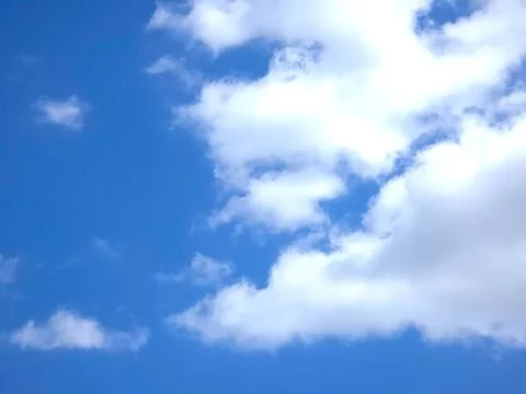 Bright Blue Sky With White Clouds on a Clear Day in the Afternoon Stock Photos