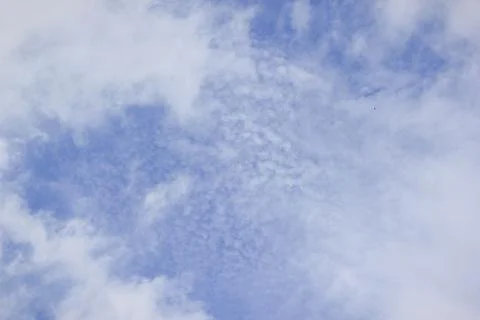 Bright blue sky with white, patchy clouds on a sunny day providing a peacef.. Stock Photos