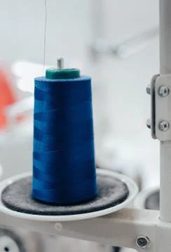 Bright blue thread bobbin on a sewing machine Stock Photos