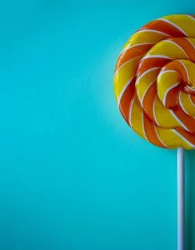 Bright blue vertical background with half swirl lollipop with copy space Stock Photos