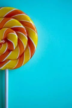 Bright blue vertical background with half swirl lollipop with copy space Stock Photos
