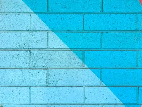 Bright blue wall with diagonal design and texture captured in an urban area.. Stock Photos