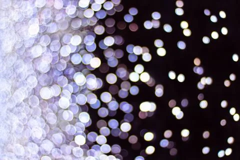 Bright blurry multi-colored bokeh lights on a dark night background Stock-Fotos