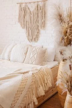 Bright boho style bedroom with macrame decor. Stock Photos