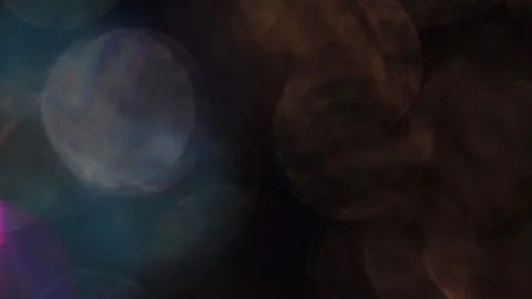 Bright bokeh in the background. Large full-screen light leak in black. Stock Footage 319394463