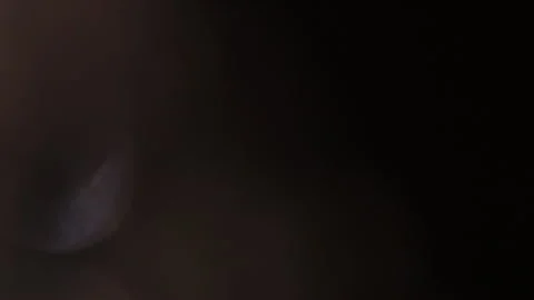 Bright bokeh on the left in the dark Stock Footage 309422365