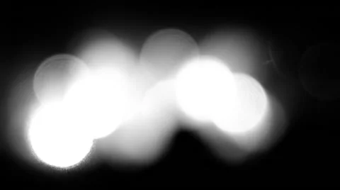 Bright bokeh lights are shining, then focusing on the audience in a concert. Stock Footage