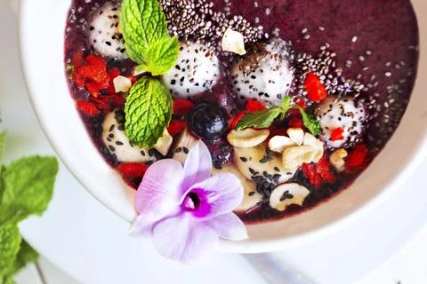 A bright breakfast of smoothies in a plate on a white background . Stock Photos