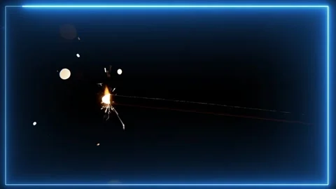 Bright burning sparkler stick emitting glowing golden sparks against a dark blue Stock Footage 335668176